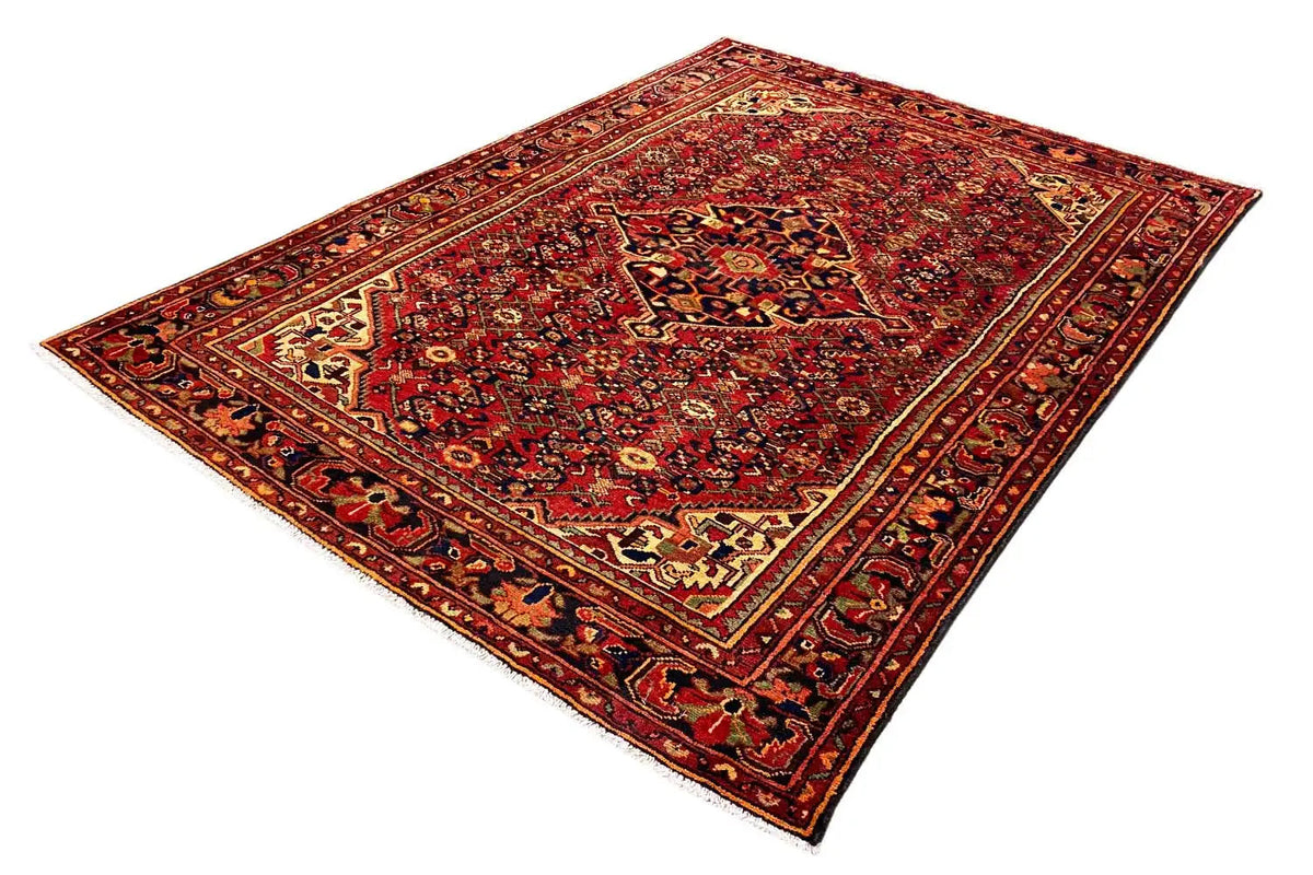 Hamadan rug laid flat, red all-over pattern with a blue and beige border frame