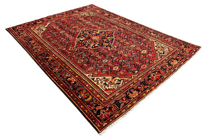Flat red Hamadan rug with a fine border and central ornaments