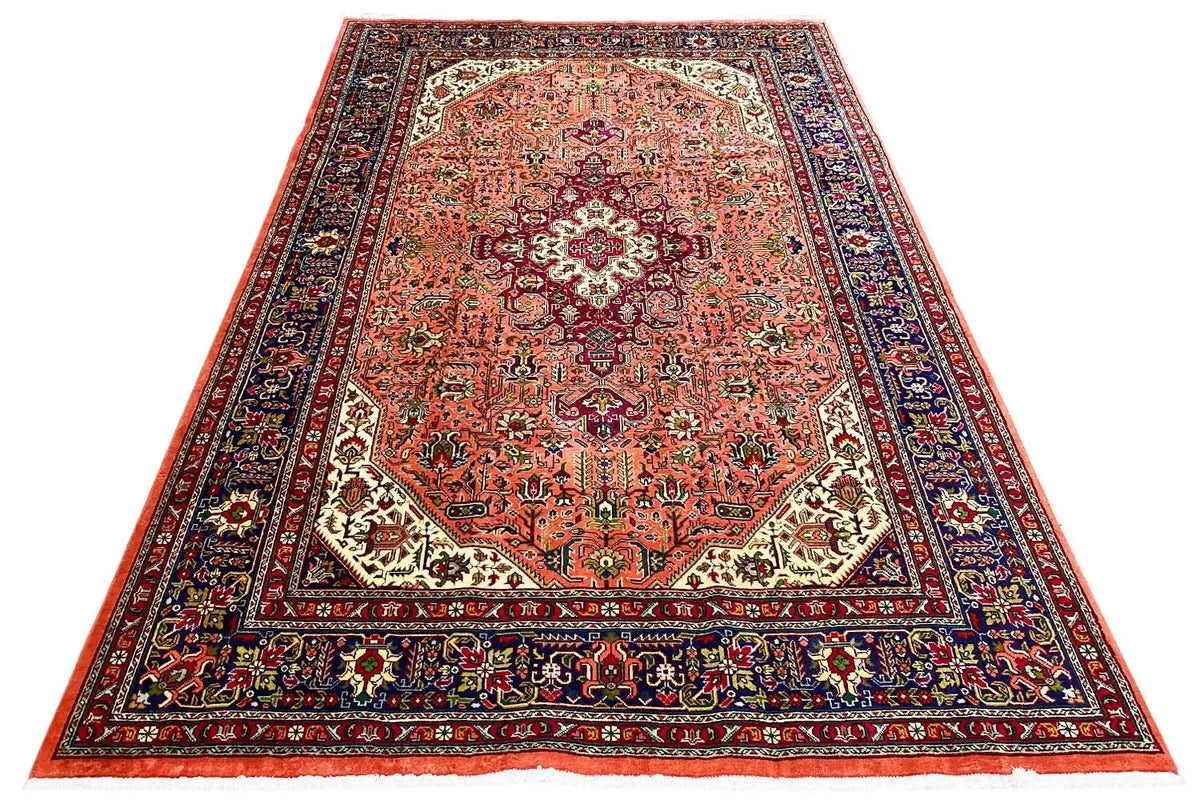 Rectangular Tabriz rug with a red-orange field, dark border, and ornaments
