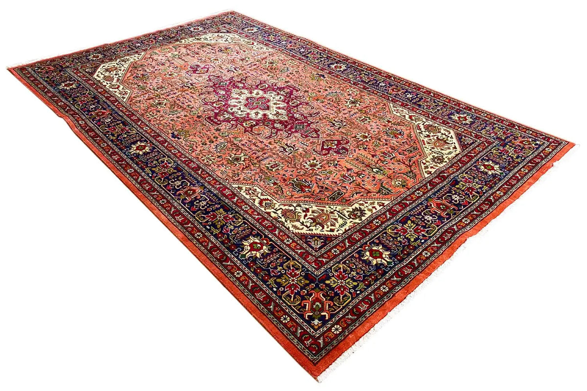 Versatile Tabriz rug with an oriental ornamental field in red, beige, and dark blue
