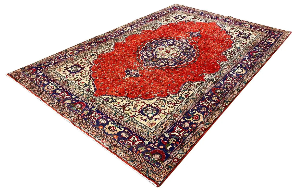 Oriental rug with a red central motif, cream-colored border ornaments, and a blue border