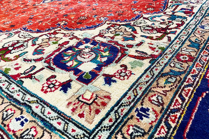 Rug detail: red field with ornaments, cream ground, blue-red decorative border line