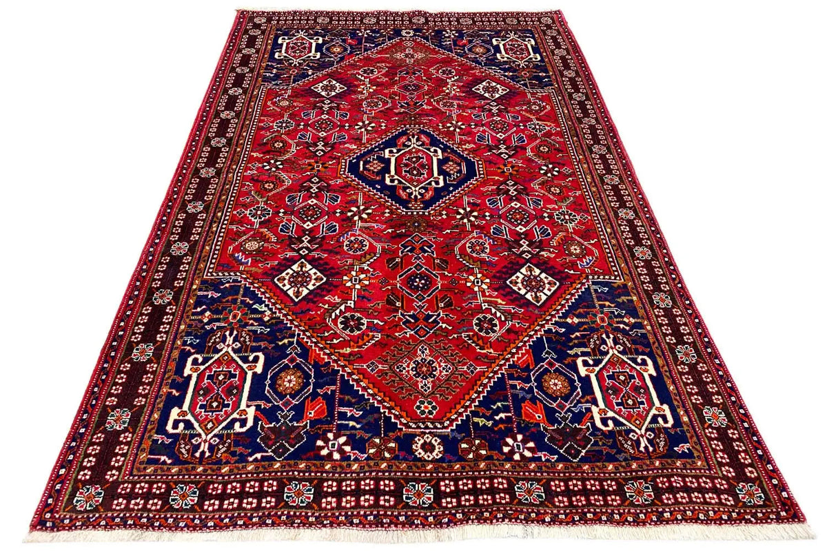 Rectangular rug with a red field, blue-and-white border, and ornaments
