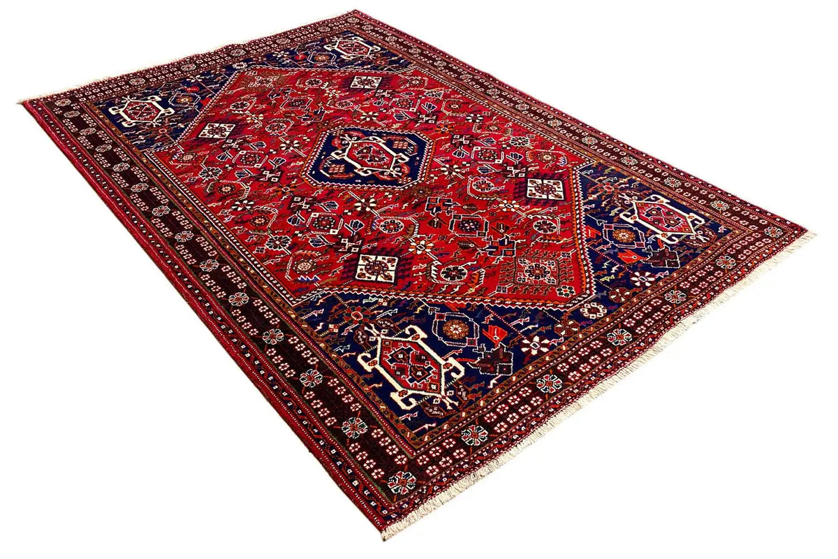 Red-and-blue carpet area with geometric ornaments and a dark border
