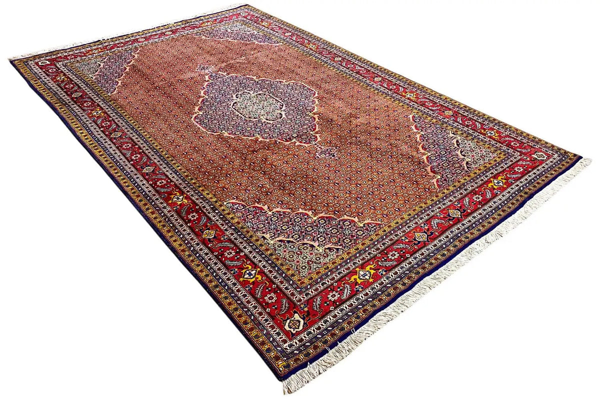 Moud rug in reddish brown with a central medallion and colorful borders