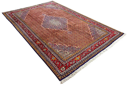 Moud rug in reddish brown with a central medallion and colorful borders