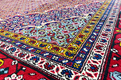 Moud rug detail: colorful floral motifs, multicolored border and edging