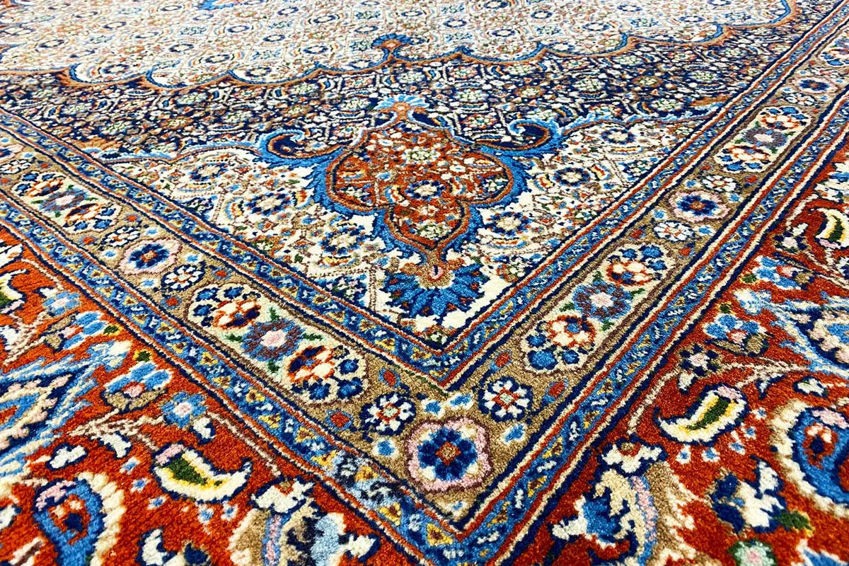 Rug detail: blue and red ornamental pattern on a beige background with decorative lines