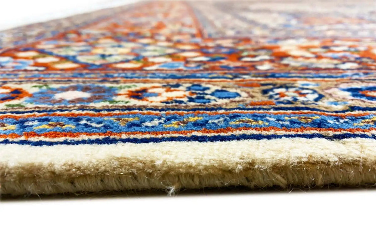 Rug edge with fringe and multicolored pile on a beige background