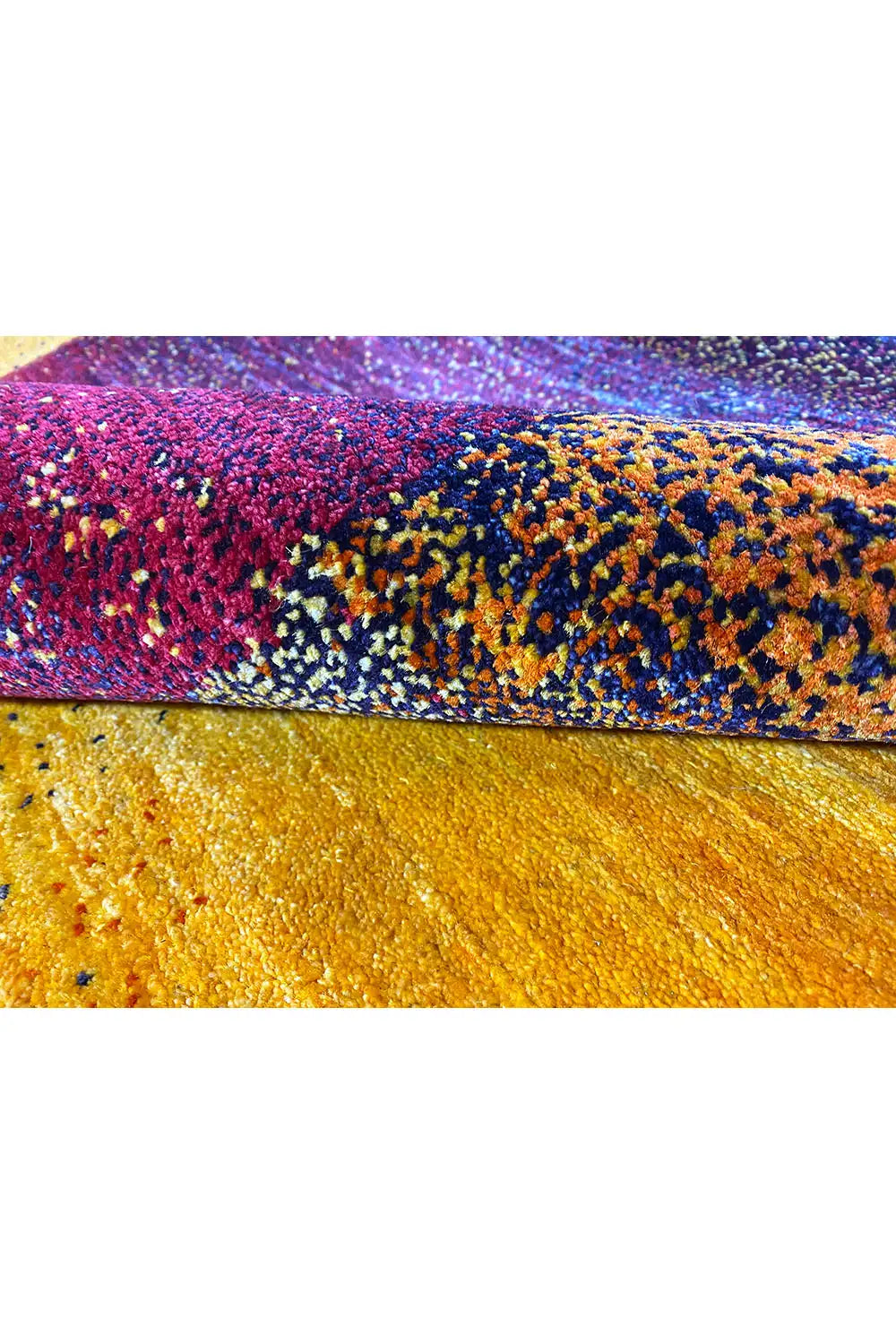 Gabbeh rug edge view with a high-pile texture, purple and yellow tones