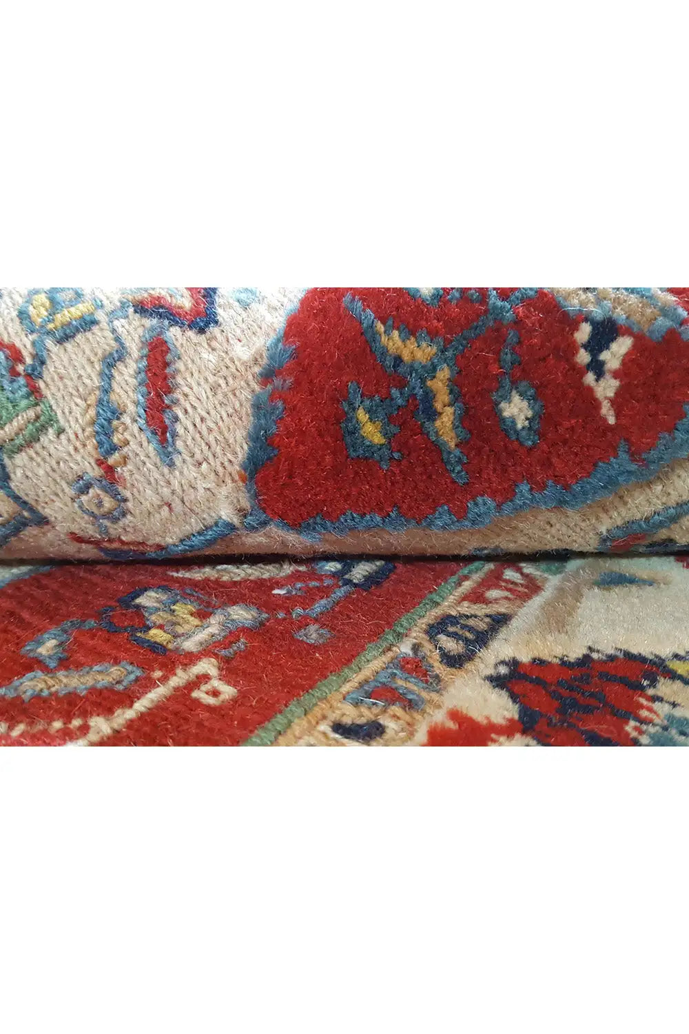 Oriental rug runner detail: blue, red, and green pattern on a light background