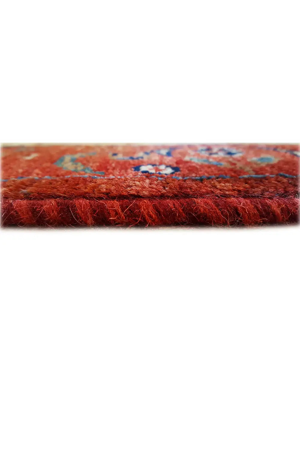 Carpet pile in reddish brown, close-up of the textile surface from the side