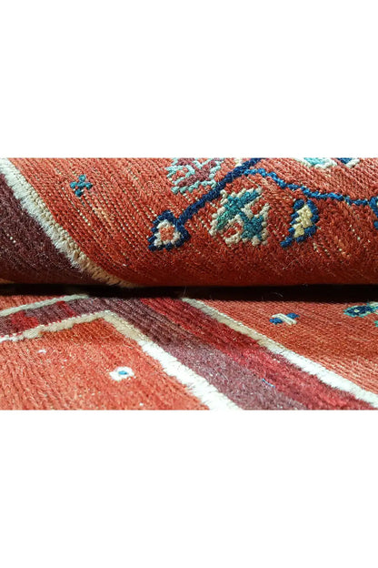 Soumak rug: close-up of the woven red pile with blue-decorated motifs.