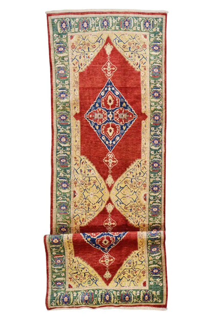 Oriental rug with a red field, multicolored vines, and a central medallion