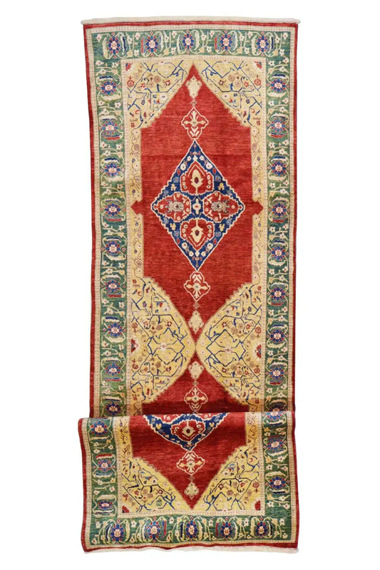 Oriental rug with a red field, multicolored vines, and a central medallion