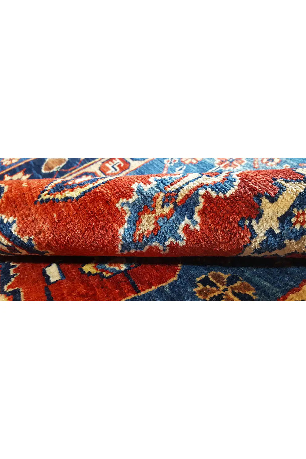Rug edge with fringe, red and blue ornamental pattern in detail
