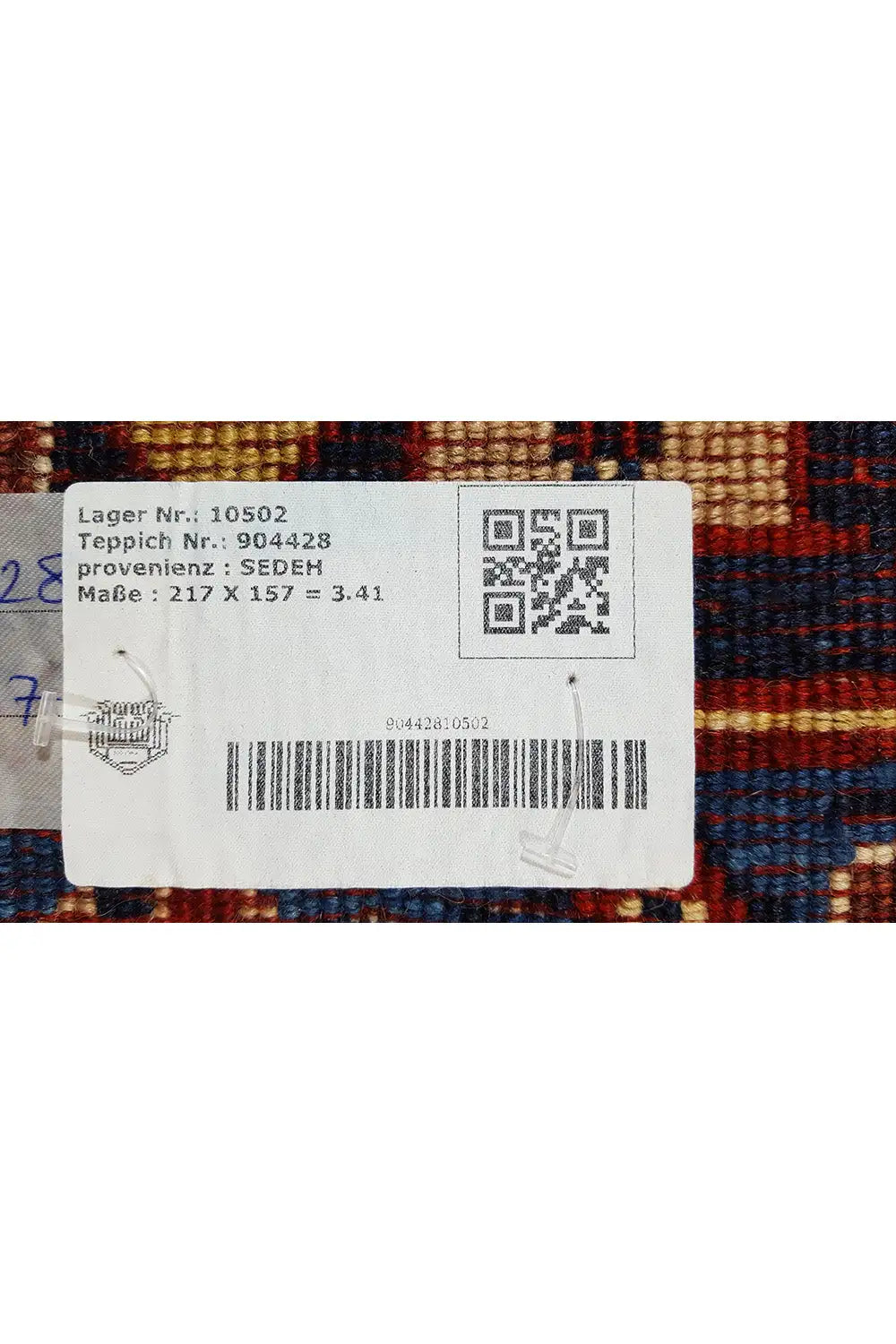 Rug with a sewn-on label and multicolored pattern