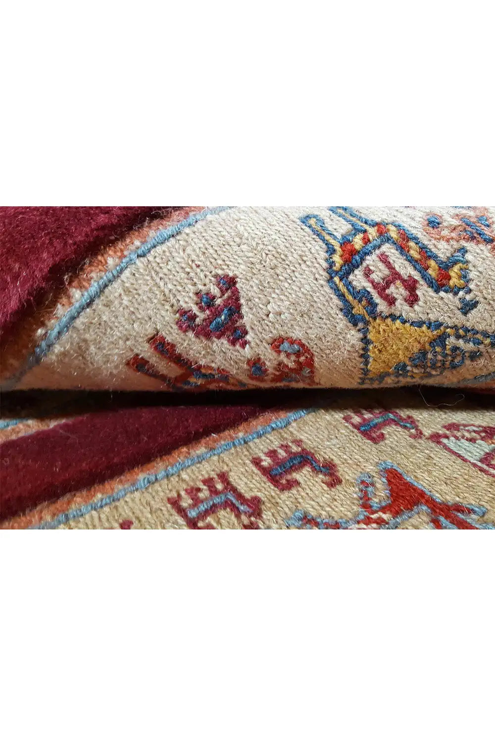 Soumak rug: Detail of the geometric pattern in beige, red, and blue, densely woven