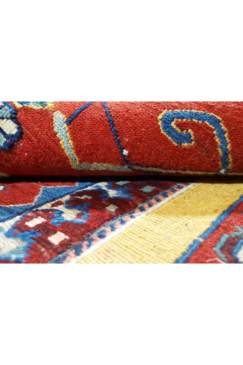 Carpet detail: red field with geometric ornaments in blue, yellow, and white