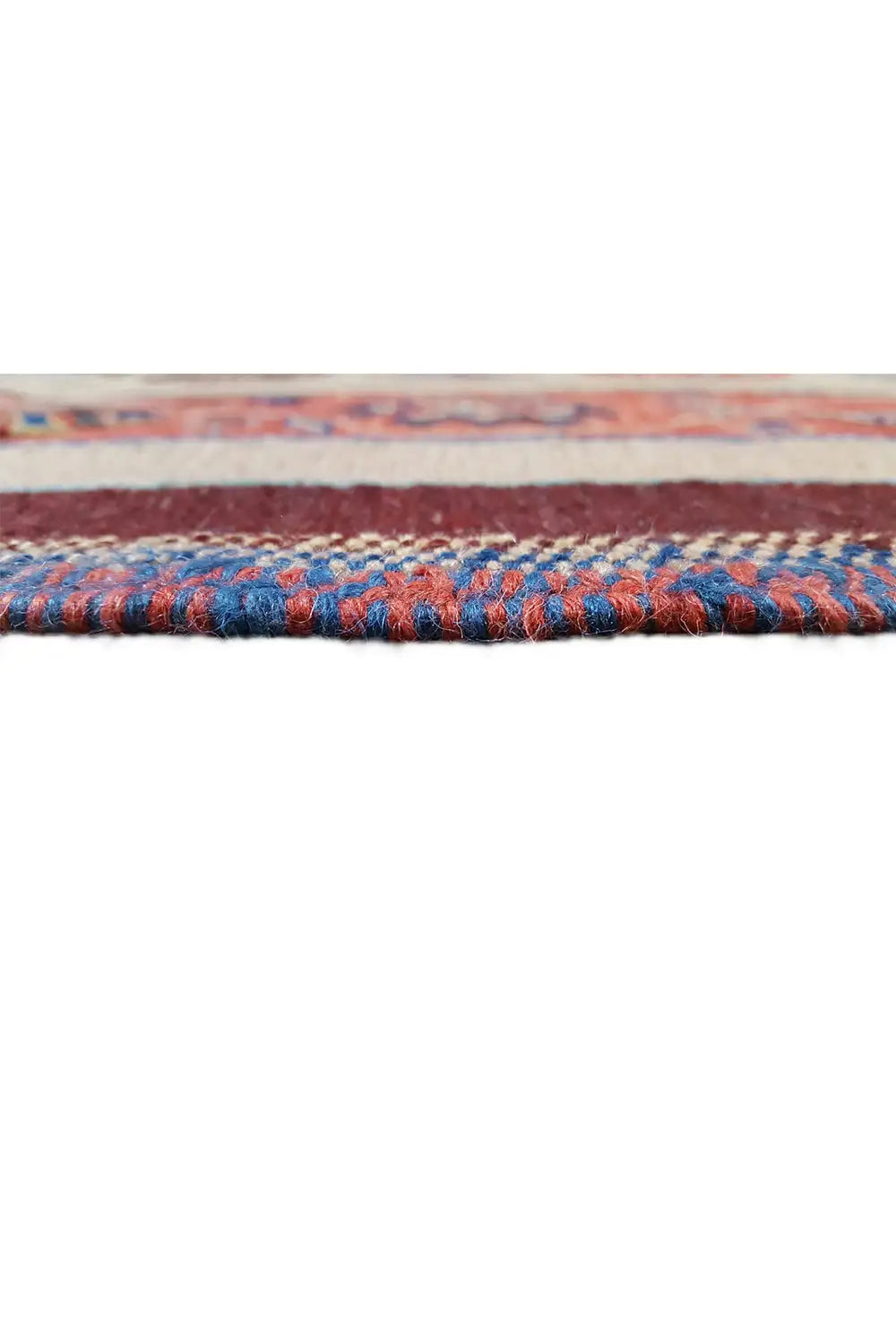 Carpet edge with a blue decorative stripe and dense selvedge, trimmed in multiple colors