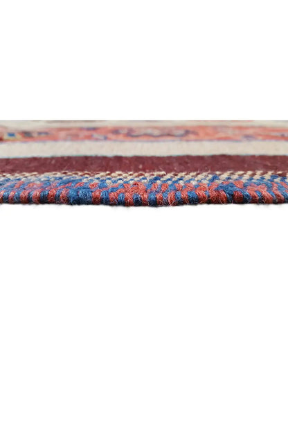 Carpet edge with a blue decorative stripe and dense selvedge, trimmed in multiple colors