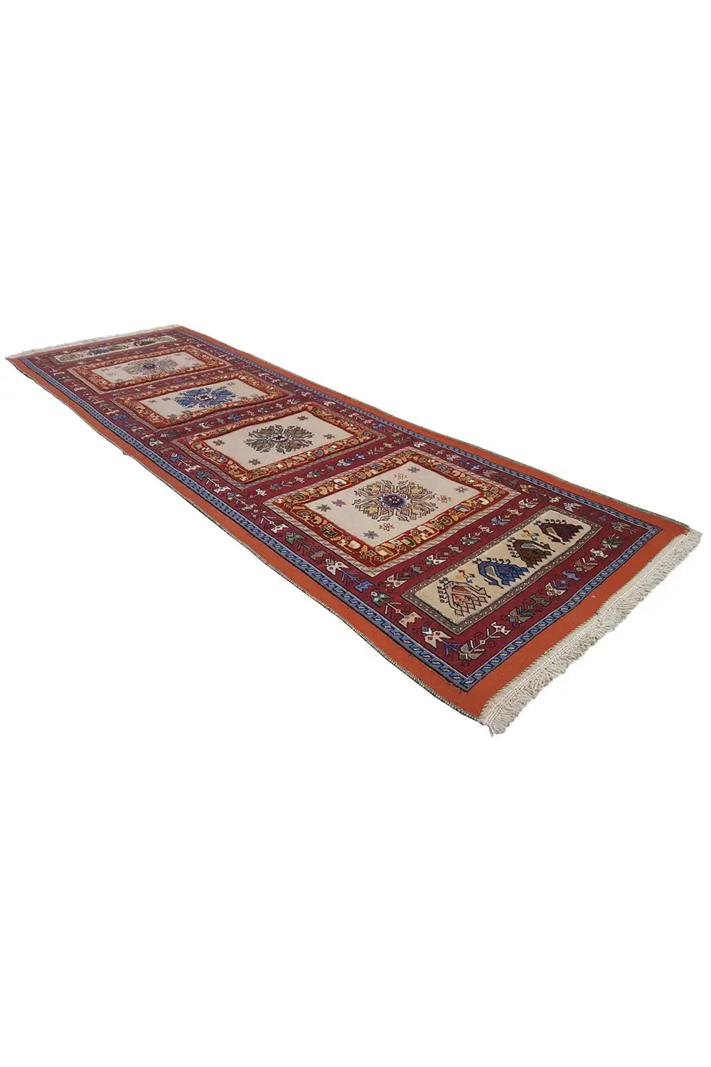 Runner rug with a block medallion design, dark red and blue, with fringed edges.