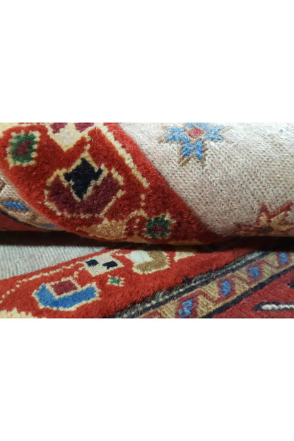 Close-up of runner rug: multicolored medallions on a light background, edges with selvedge.