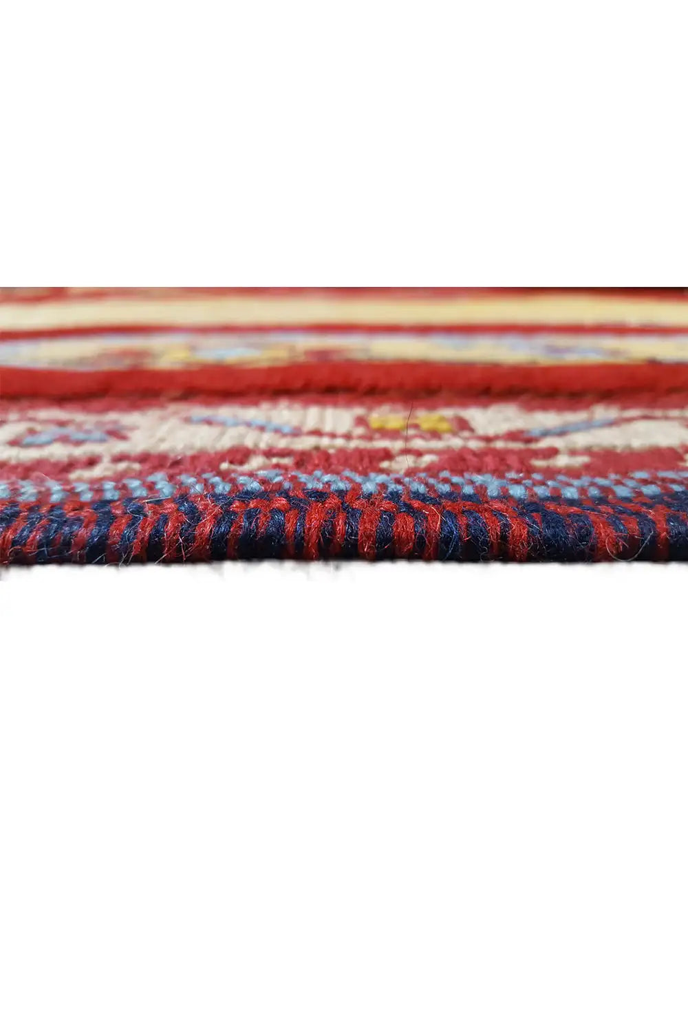 Close-up of the carpet edge, colorful fringe, and multilayered border