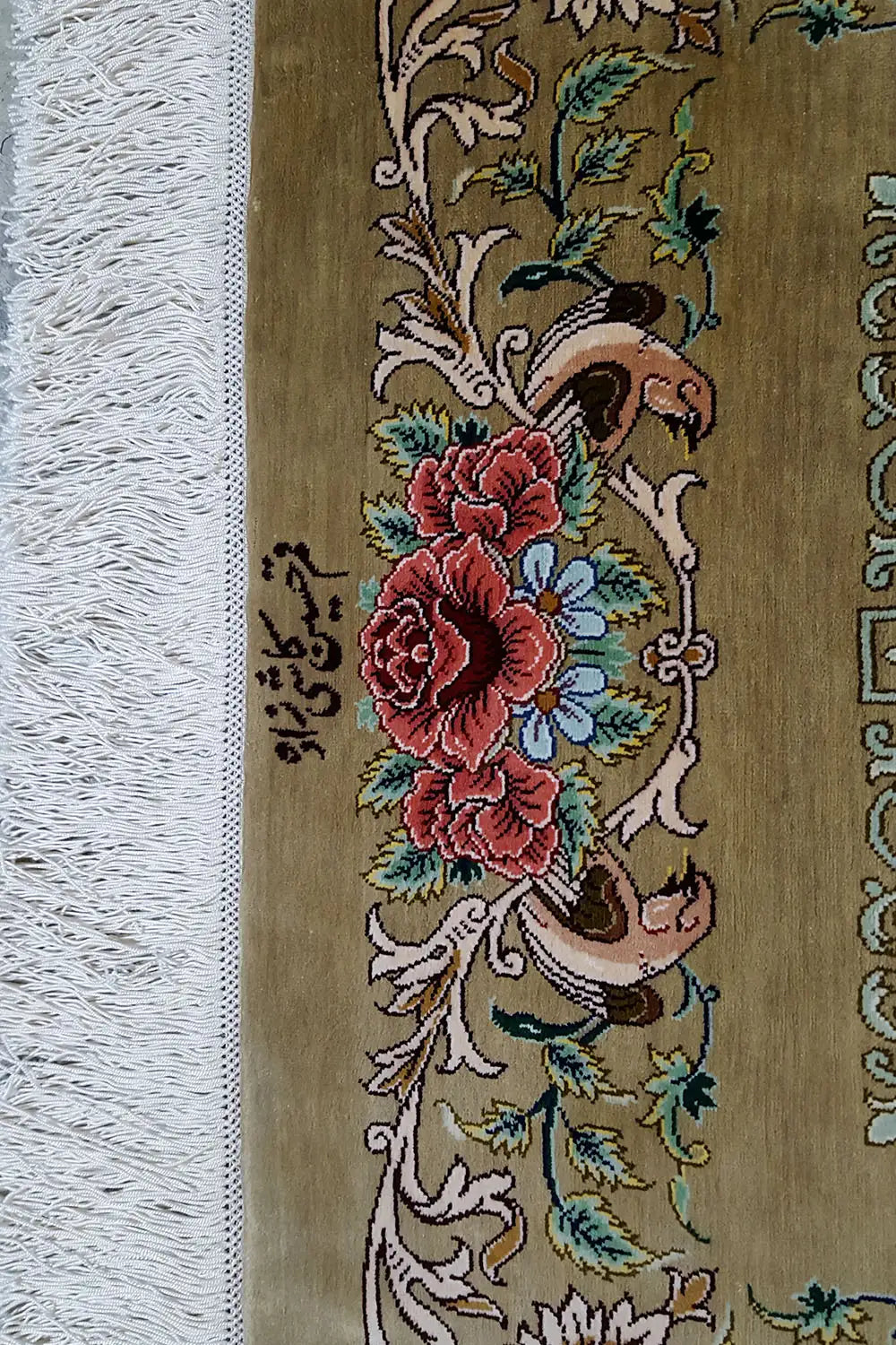 Silk rug with floral ornaments in shades of brown and green, colorful blossoms, and fringes