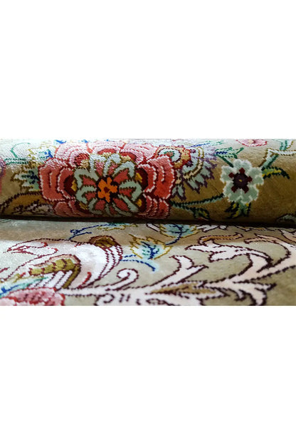 Silk rug in olive with colorful floral borders and decorative lines, with fringes