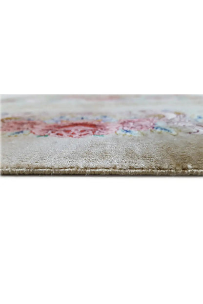 Silk carpet close-up of the selvage with light-colored fringes and a multicolored pattern