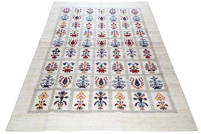 Rectangular Gabbeh-Lori rug on a beige background with colorful small ornaments in a grid.