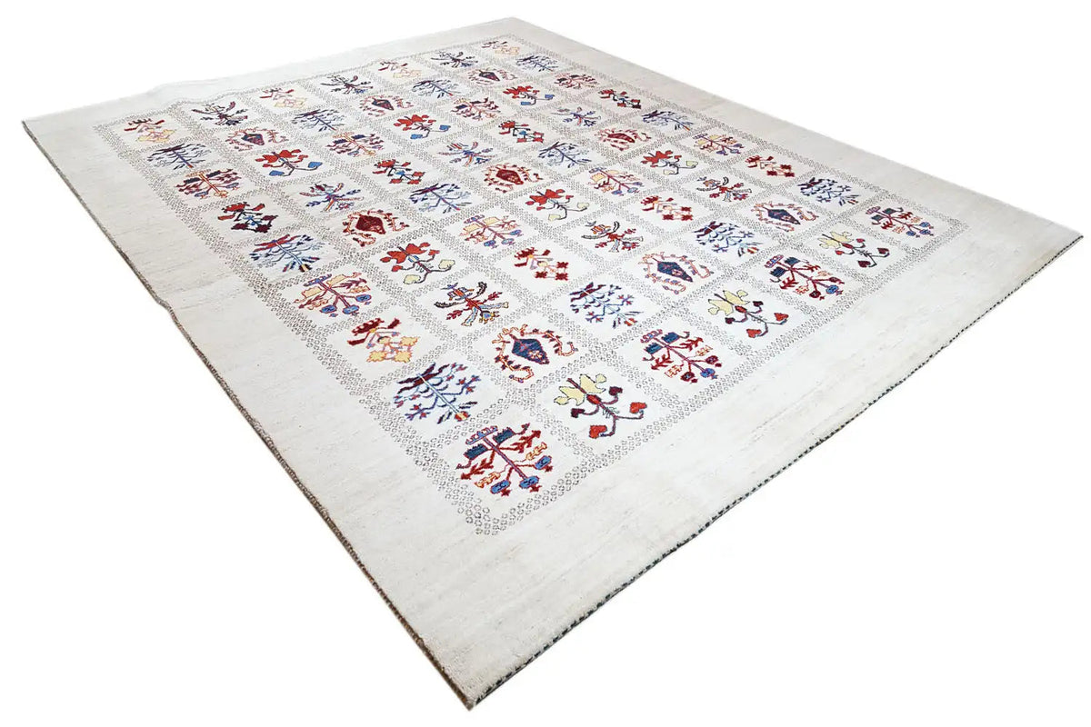 Gabbeh Lori rug with a beige pile and a dense pattern of colorful medallions.
