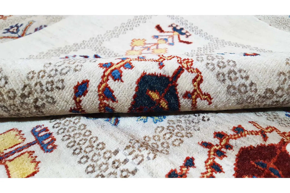 Carpet detail: colorful animal and ornamental motifs on a beige background, crisp pile.