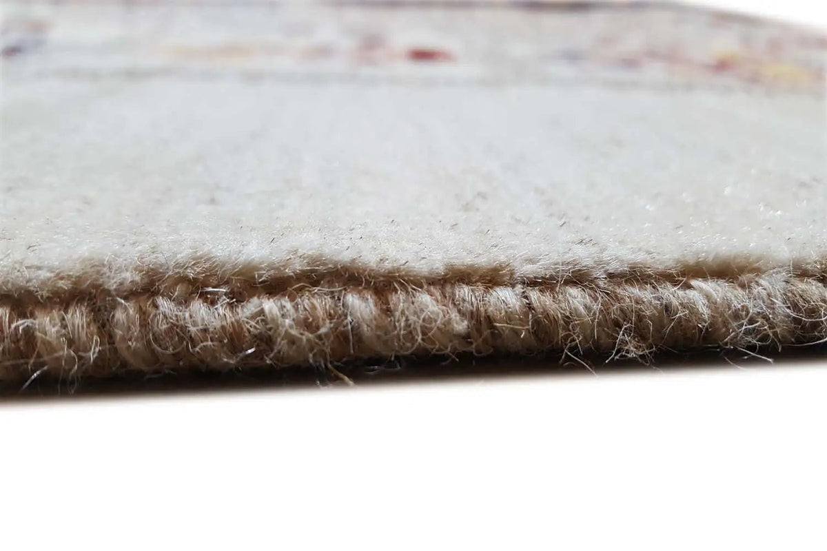 Rug edge with short pile and natural-colored fringe along the edge.