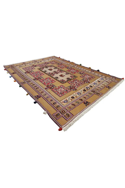 Rectangular Oriental rug with a patterned border, red center, and colorful embellishments