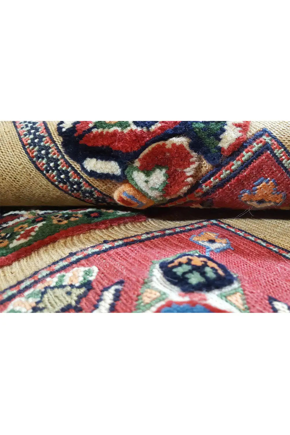 Close-up of the Oriental rug: colorful floral pattern, woven details, textile pile
