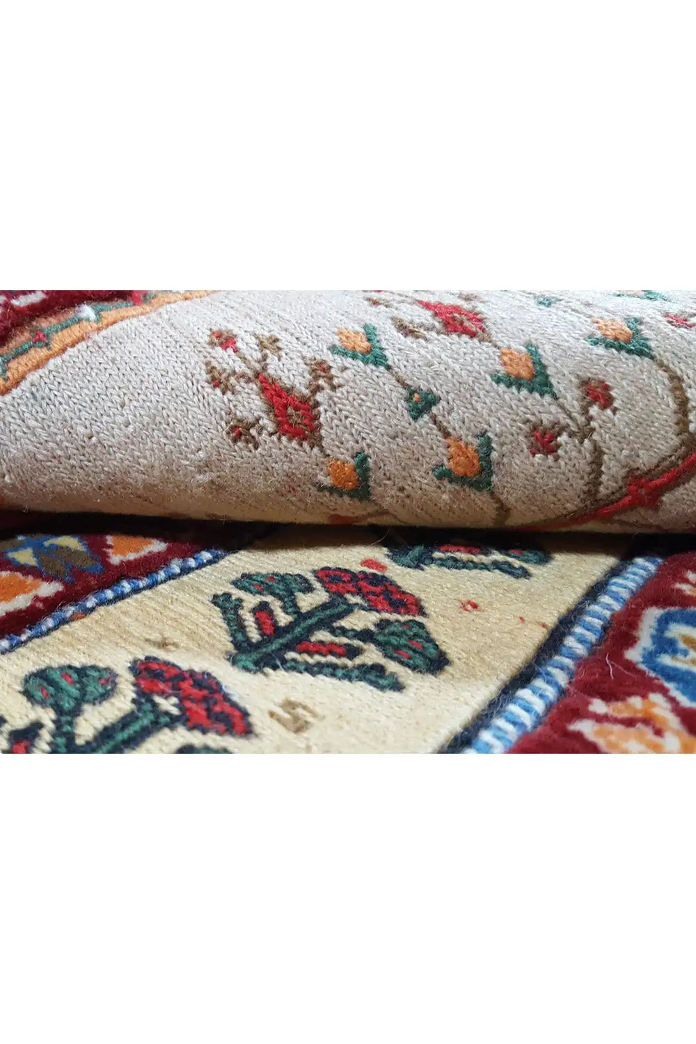 Rug detail: light selvedges with multicolored motifs and a twisted edge