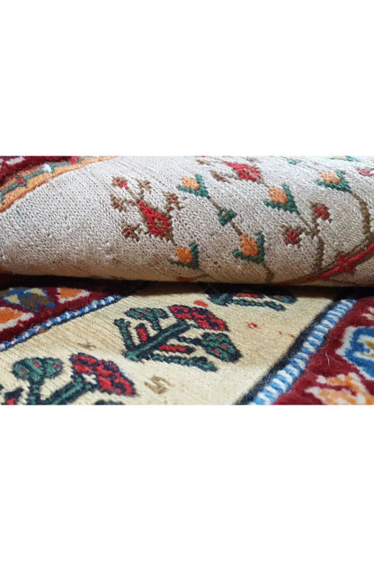 Rug detail: light selvedges with multicolored motifs and a twisted edge