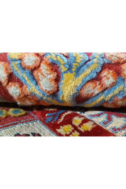 Close-up of a Soumak rug, multicolored border and floral motifs, visible texture