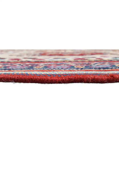 Rug edge with red fringes and multicolored stripes, knotted fabric.