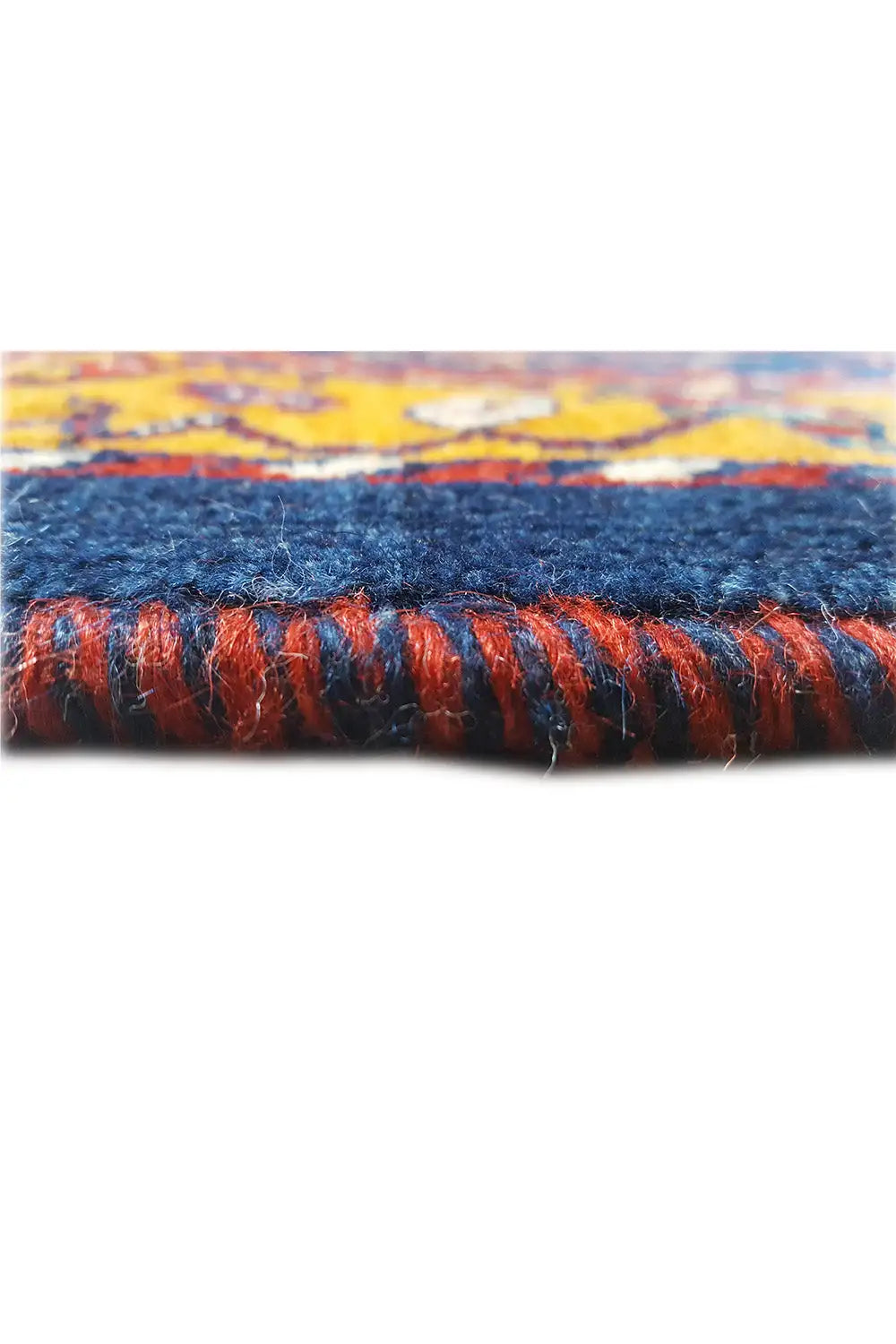 Gabbeh rug close-up: blue ornamental pattern with orange-red fringes, border.
