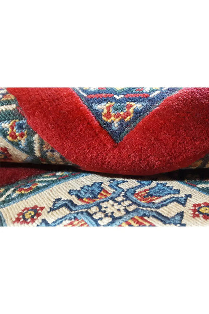 Soumak rug: close-up with red pile and a blue ornament in the foreground