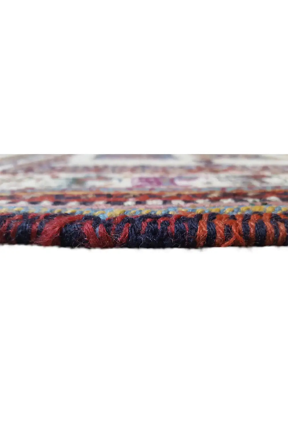 Rug edge with multicolored fringe trim along the short side