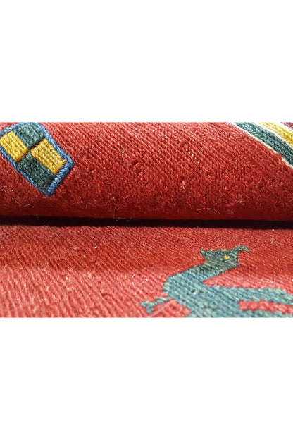 Soumak rug: close-up of the pile and border, red background with a blue pattern
