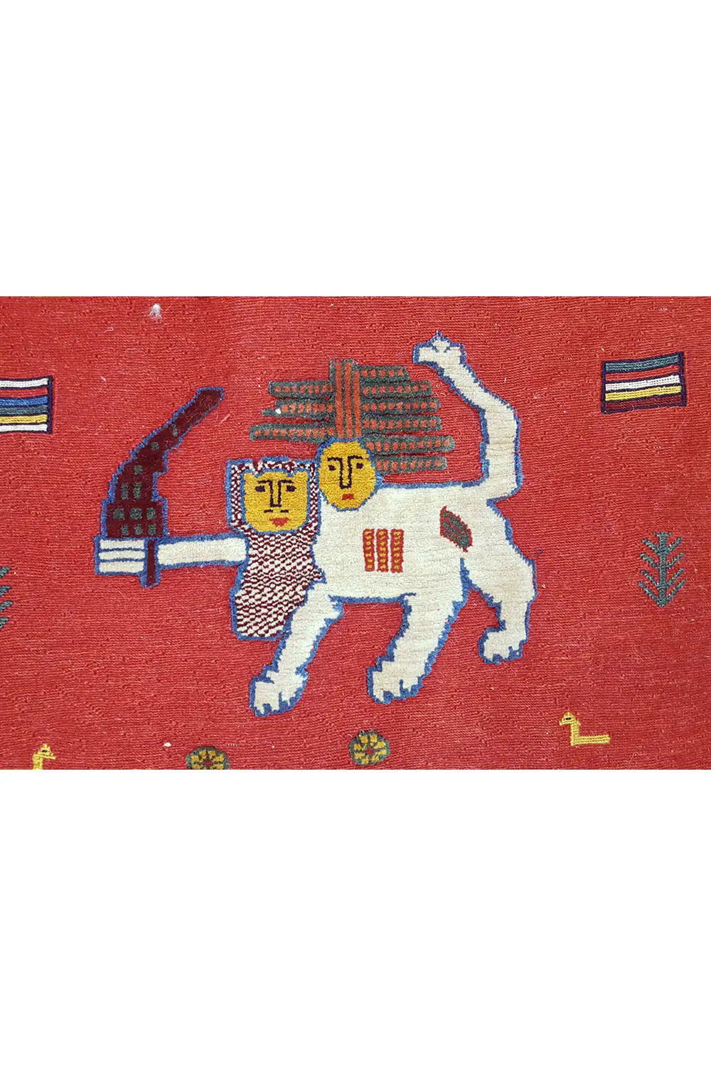 Soumak rug: close-up of a design with large figures on a red background and colorful accents