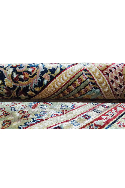 Machine-woven carpet detail: border and patterned tiles, multicolored, with short fringes