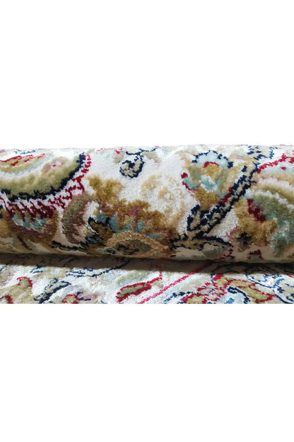 Close-up: carpet with a folded edge and colorful ornamental pattern, pile with fringes