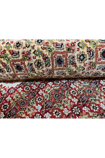 Carpet with a colorful floral and vine pattern in red, green, and blue
