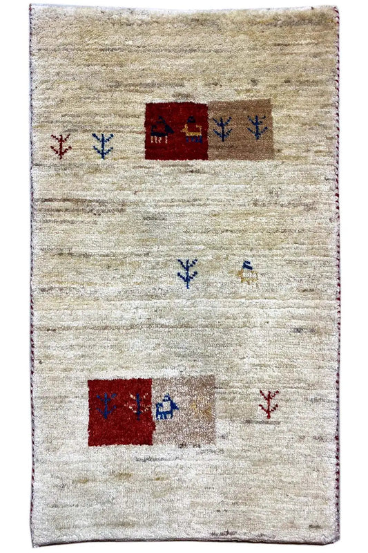 Gabbeh rug with beige pile and red, blue, and brown sections in a linear pattern